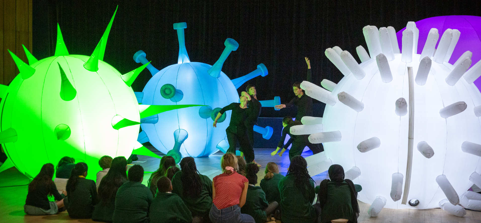 Children watch a science-inspired dance performance
