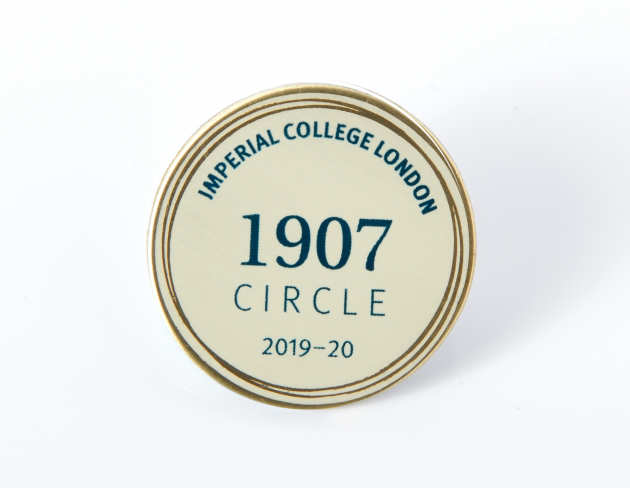 A cream coloured 1907 Circle badge