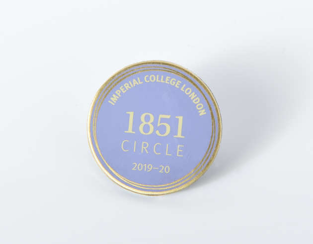A pale blue 1851 Circle badge