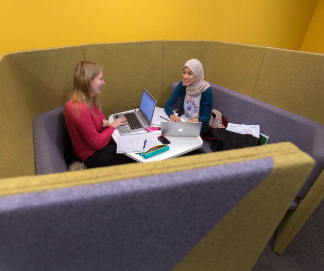 Students chatting together in the library