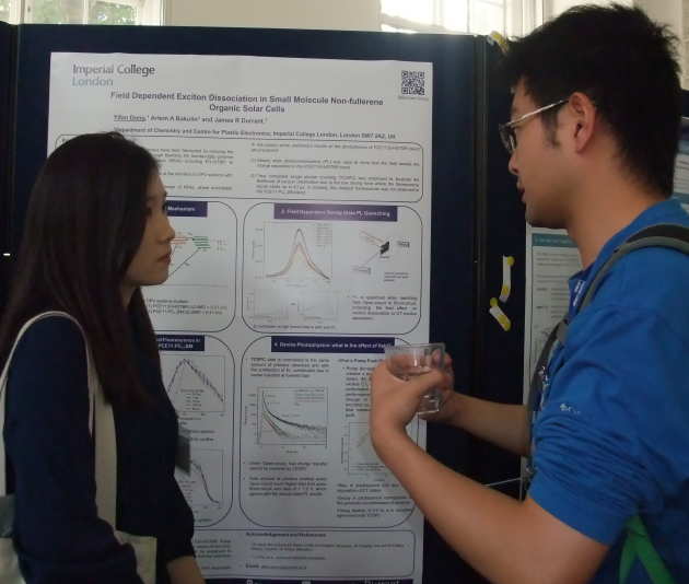 Male and female student discuss scientific poster