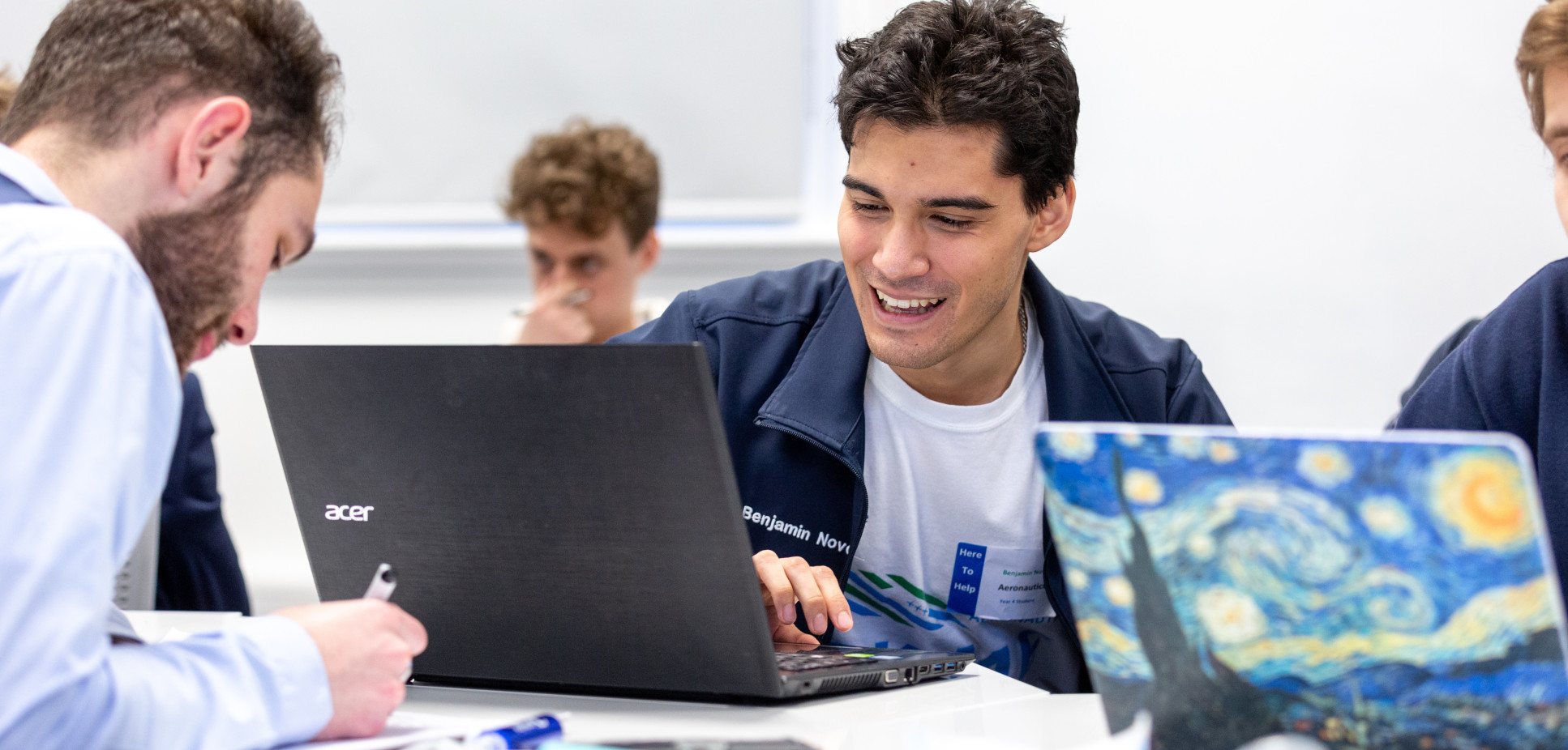 Chatting students on laptops