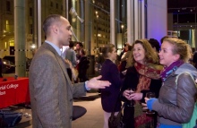 Researcher speaking with visitors at previous Imperial Fringe event