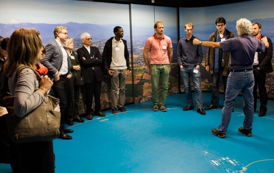 CERN tour guides show alumni a graphical depiction of the 27 kilometre long facility