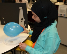 Pupil demonstrates how to seperate salt and pepper with static from a balloon