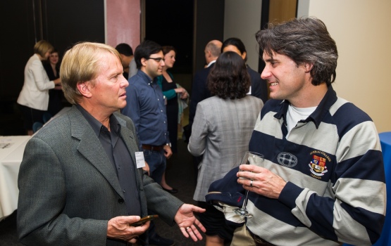 Charlie Kissick, President of the alumni chapter in Northern California, chats to guests