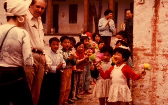 Foreign visitors entering rural Chinese elementary school for performance, 1976