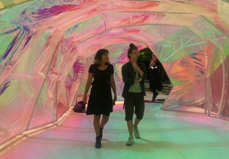 People visiting the Serpentine pavillion, inside a coloured plastic sculpture