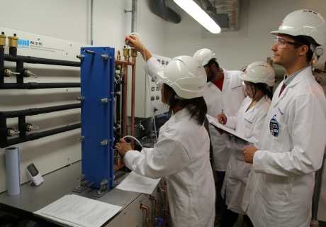 Summer school students working on the new heat exchanger teaching rig