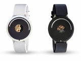 one black and one white gadget that look like watches