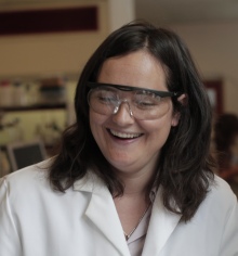 Professor Charlotte Williams in lab coat and glasses