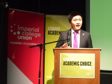 young man speaking at podium