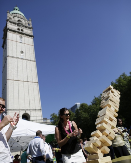 A jenga tower topples in front of the Queen's Tower