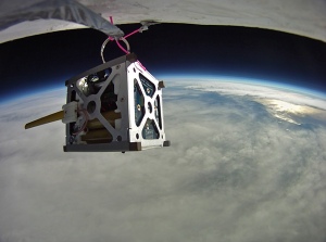 Small cube satellite above the Earth