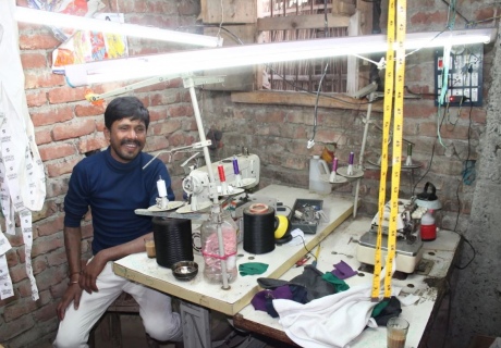 Man at a sewing station