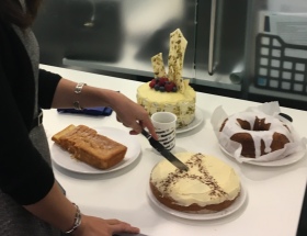 Cutting a cake with the Eiffel Tower on it