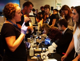 Visitors talking to organisers and volunteers at the Imperial College stand