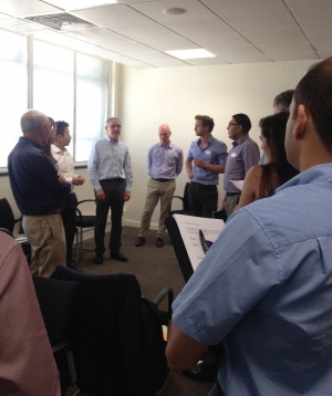 Group of researchers standing to discuss collaborative work