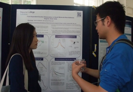 postdoc and student discussing a poster