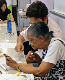 An elderly woman getting help with 