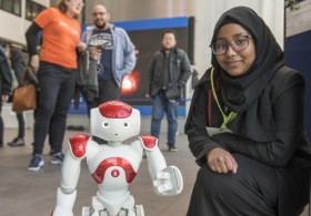 Visiting school student Ahona Islam with the outreach robot