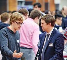 Two people speaking at a careers fair