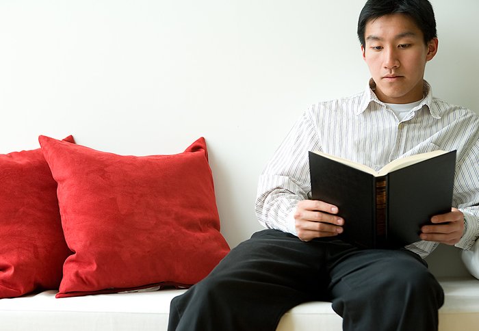 Young asian man reading