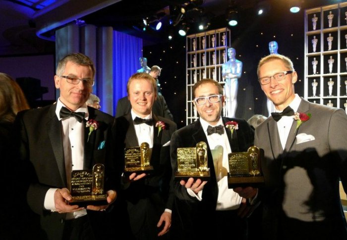 Allan Jaenicke (second from left) and John-Paul Smith (far right) receive their Oscars