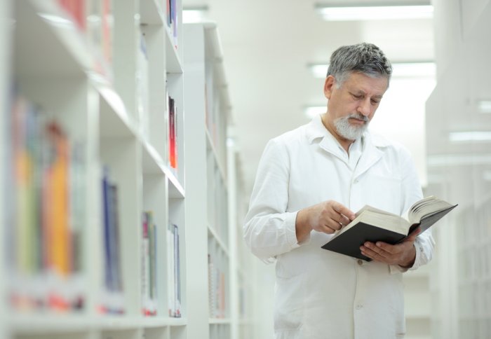 Doctor reading in a Library