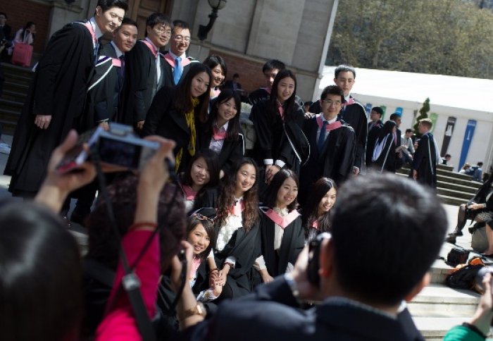 Students on the steps of the Queen's Tower