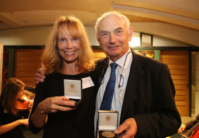 Professor Joanne P Webster and Professor David Molyneux holding their respective medals