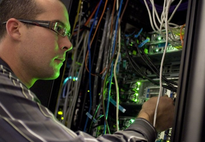 Member of Staff maintaing doc mainframe computer