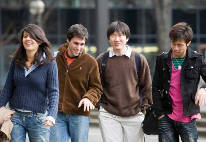 Some students walk through the campus. Perhaps they're thinking about internships.