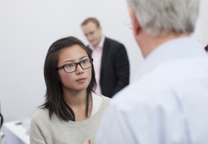 A student talks to a company leader.