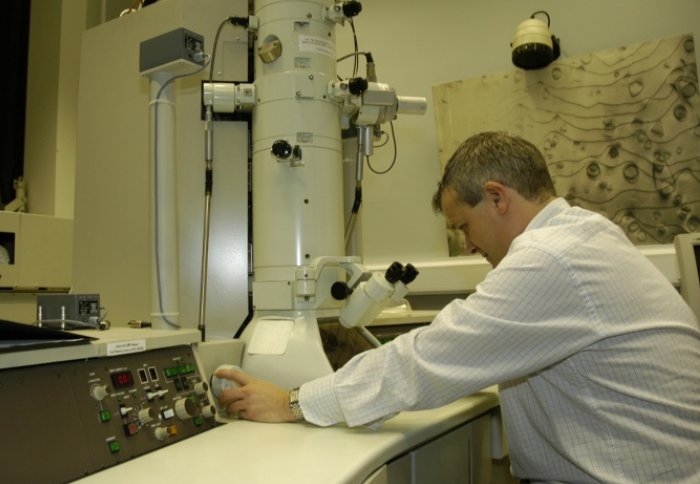 Scientist looking through microscope