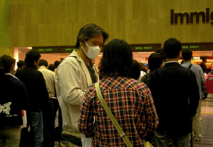 Passengers wearing facemasks at Singapore international airport