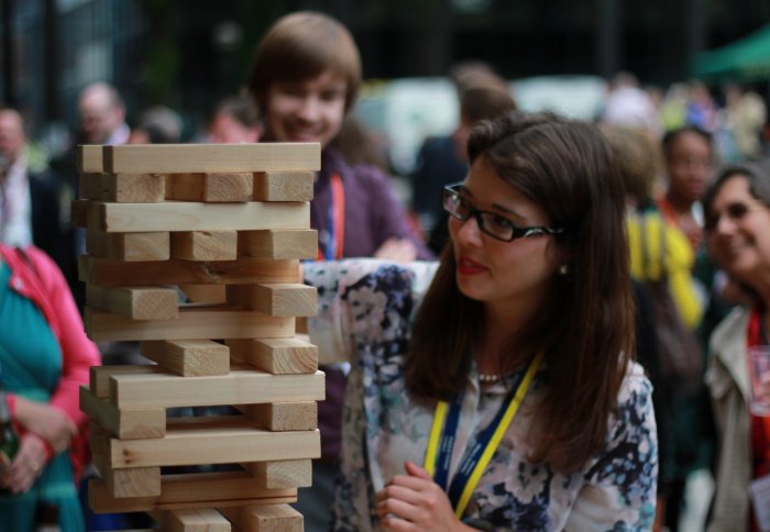 staff member playing Jenga at the summer fête