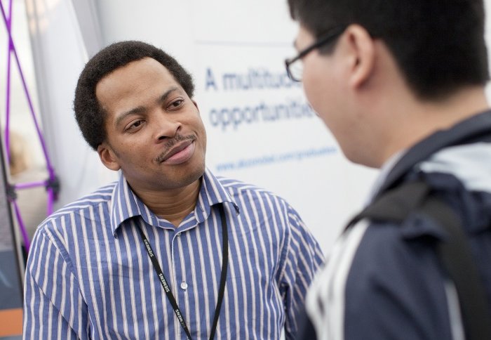 An employer talks with a student.