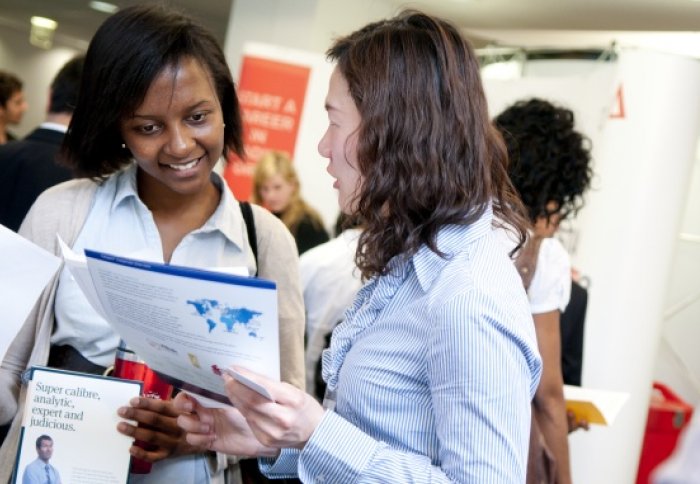 A student speaks with an employer about financial careers.