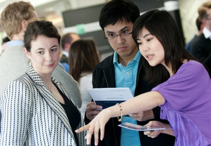 Students with an employer at a careers fair.