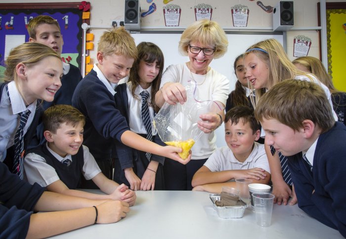 Professor Maggie Dallman of Imperial College London uses tights and bananas to demonstrate the digestive system to students at Hayes Primary School in Bromley