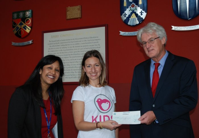 Jeff Magee and Su Nandy present Kids Company with the cheque raised by the BBQ raffle