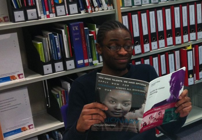 A well-informed student browsing a copy of the Imperial Careers Service's 'Guide to Career Planning 2014-15'.