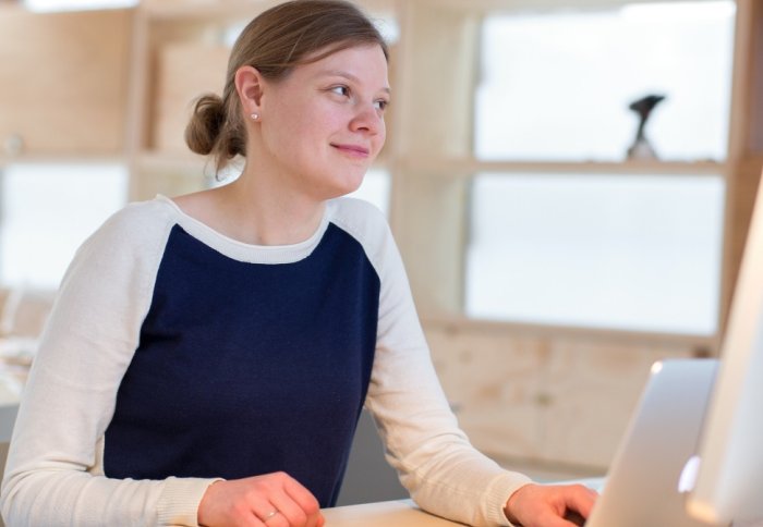 Woman working on a laptop.