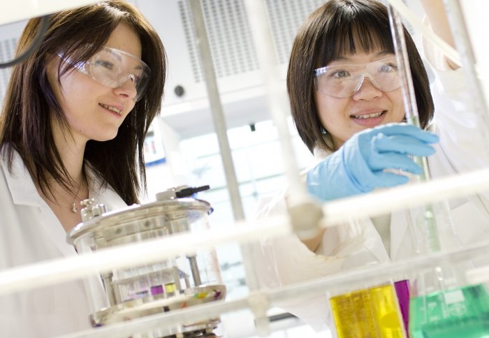 A student measures a solution using a graduated pipette.