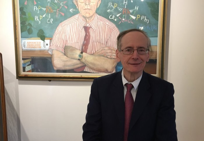Prof Marks in front of painting of his scientific grandfather Sir Geoffrey Wilkinson