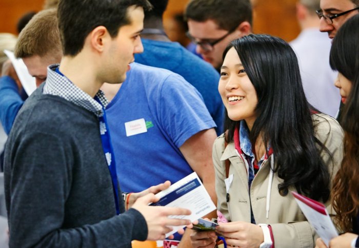 Students talk with an employer at a careers fair.