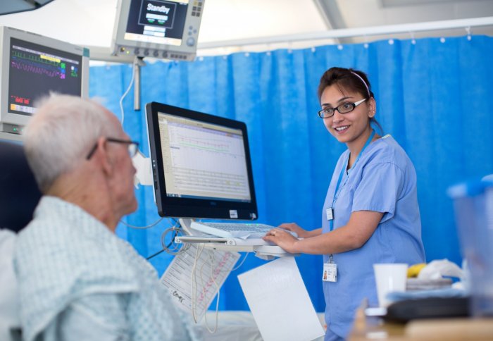 Patient and nurse in adult IC unit at Hammersmith Hospital