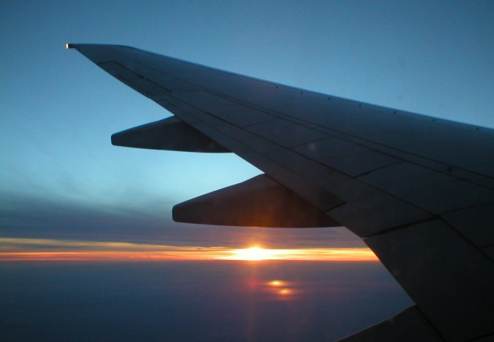 Aeroplane take off at sunset