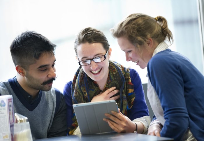 Students using an iPad on campus